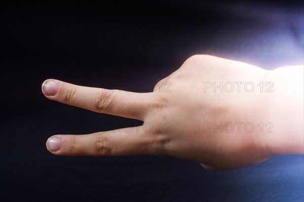 The sign of victory and peace in black background