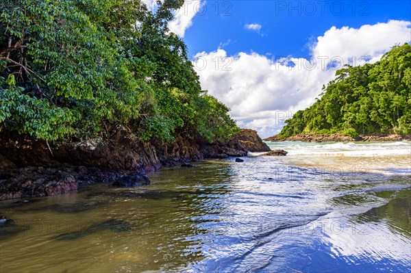 Paradisiacal and preserved beach in Itacare in Bahia between the tropical forest and the rocks