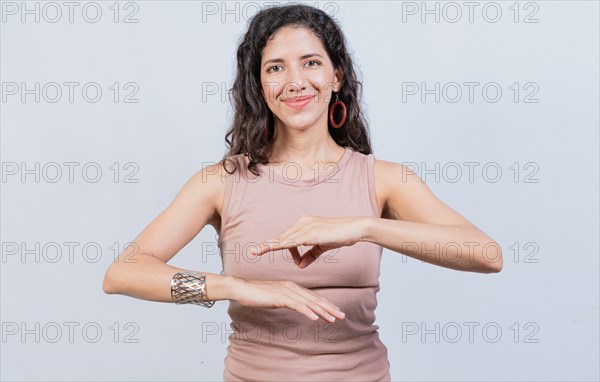 Smiling young woman gesturing in sign language. Female interpreter gesturing in sign language