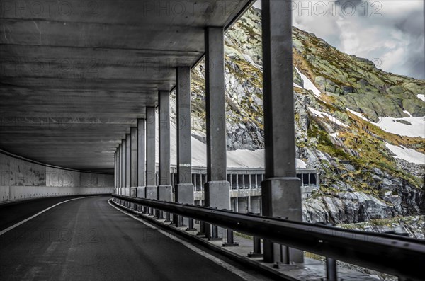 Mountain Road with Open Tunnel with Snow in Switzerland