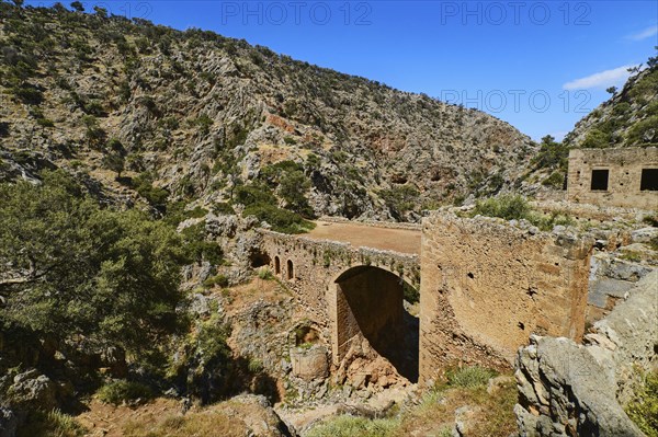 Ruins of remote abandoned Orthodox Katholiko monastery and bridge over Avlaki gorge