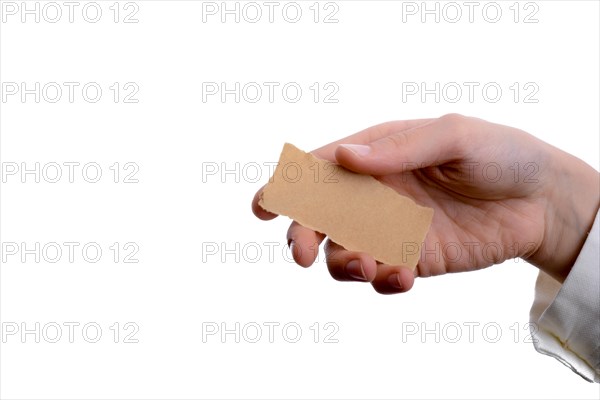 Hand holding a piece of blank torn notepaper