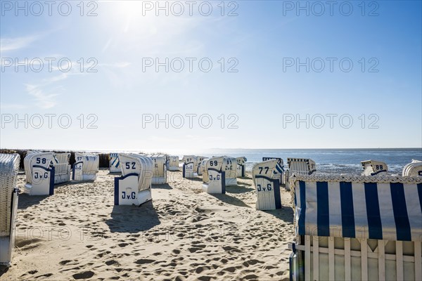 White beach chairs and mudflats