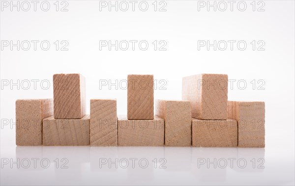 Wooden Domino Blocks in a line on a white background