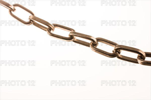 Gold color metal chain on white background