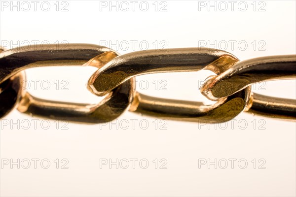 Gold color metal chain on white background