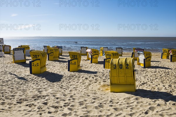 Yellow beach chairs and mudflats