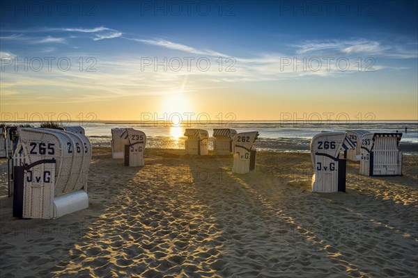 White beach chairs and mudflats