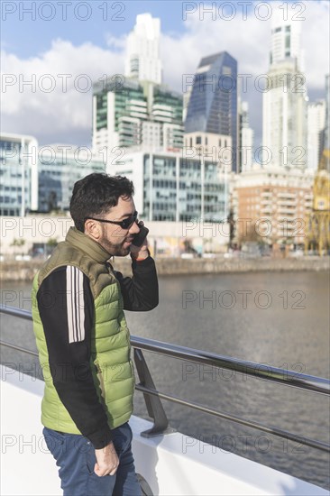 Latin man talking on the phone in Puerto Madero