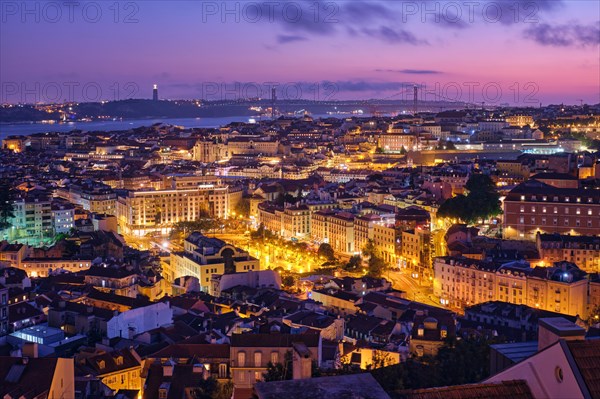 Night view of Lisbon famous view from Miradouro da Senhora do Monte tourist viewpoint of Alfama and Mauraria old city districts