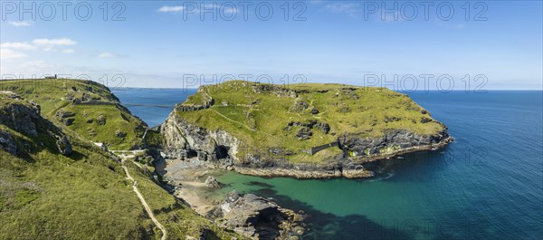 Aerial panorama of the rugged coastline on the Celtic Sea with the Tintagel Peninsula and the ruins of Tintagel Castle