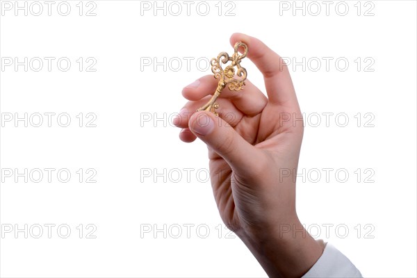 Hand holding a retro styled metal key on a white background