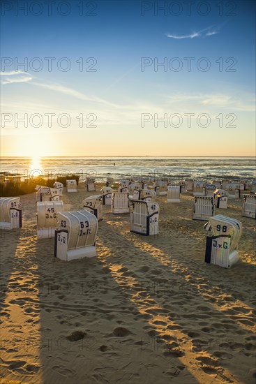 White beach chairs and mudflats