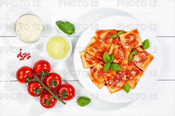 Ravioli Italian pasta eat lunch dish with plate in tomato sauce from above on wooden board in Stuttgart