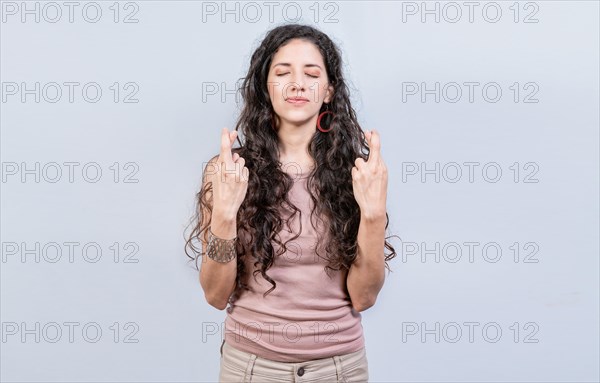 Hopeful woman making a wish isolated