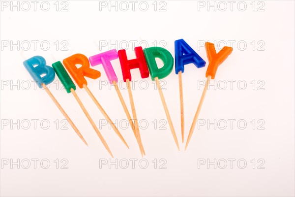 Color candles on sticks write the words birthday