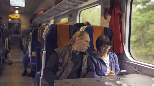 Elderly couple travel by train