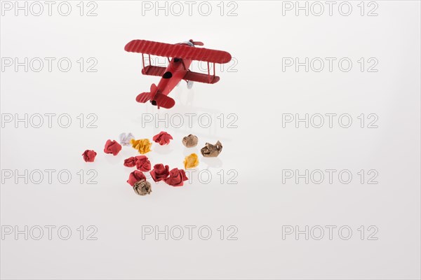 Red airplane and crumpled paper on a white background