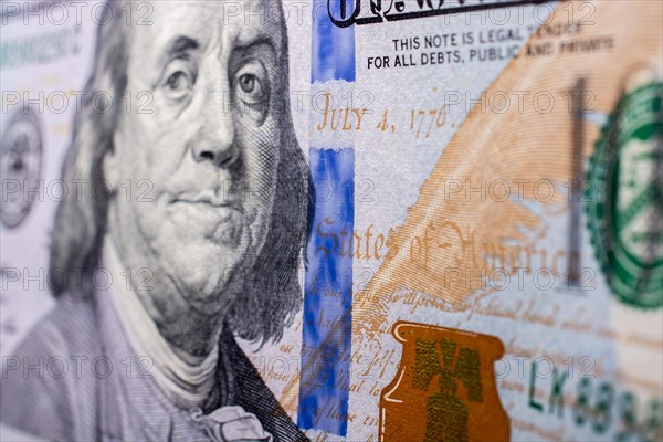 Close up of Benjamin Franklin face on 100 US dollar bill