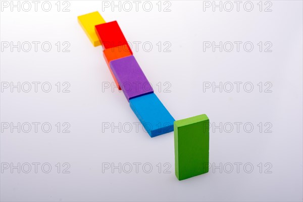 Colorful Domino Blocks in a line on a white background