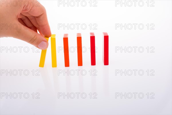 Colorful Domino Blocks in a line on a white background