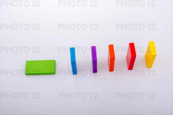 Colorful Domino Blocks in a line on a white background