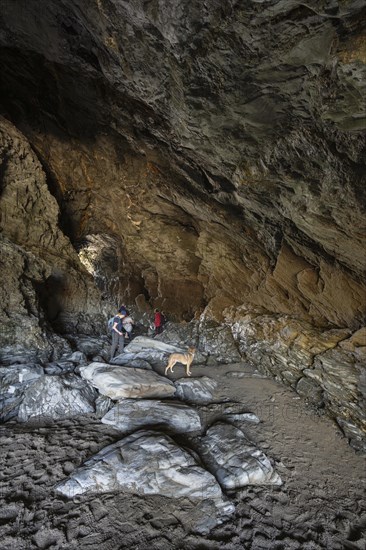 Tourists walk the fabled Merlins Cave