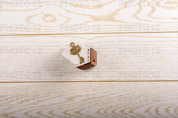 Model house and key and on parquet background