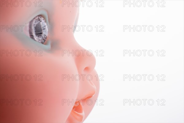 Baby doll's head on a white background