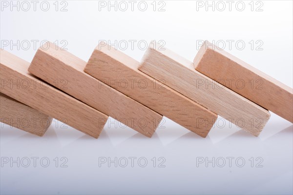 Wooden Domino Blocks in a line on a white background