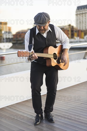 Guitar musician playing guitar in the street