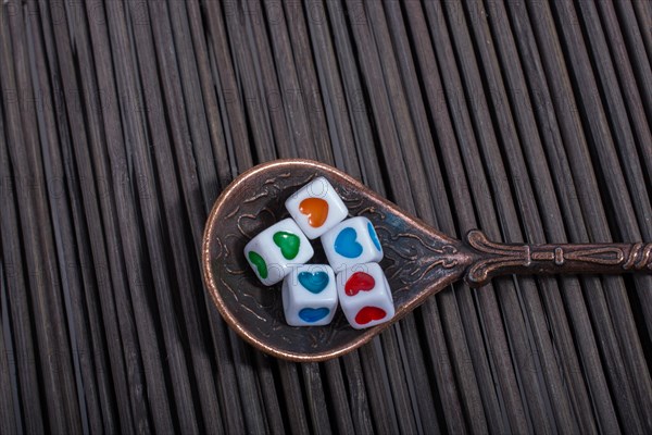 Colorful heart shaped love cubes in a spoon