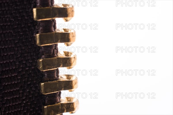 Close up or macro of a brown zipper on white background