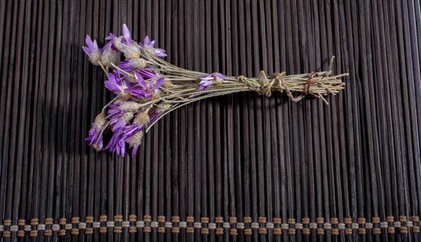 Bunch of flowers are placed on a straw mat