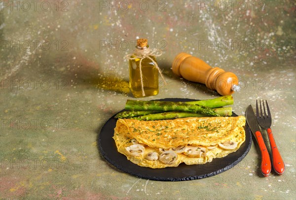 Mushroom omelette with wild asparagus on a slate