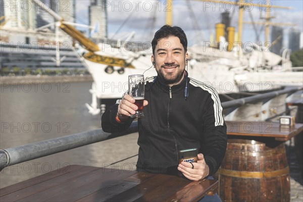 Latin tourist drinking beer