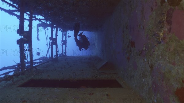 Scuba diver swim down corridor of ferry Salem Express shipwreck