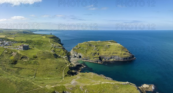 Aerial panorama of the rugged coastline on the Celtic Sea with the Tintagel Peninsula and the ruins of Tintagel Castle