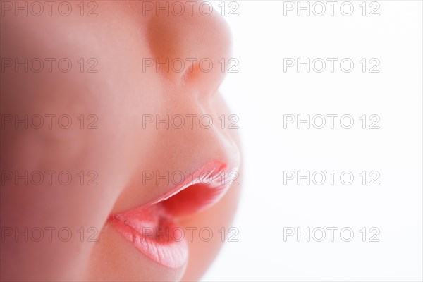 Baby doll's head on a white background