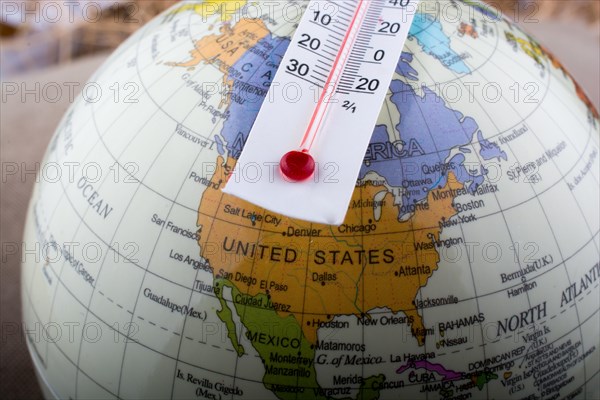 Thermometer placed on a little model globe