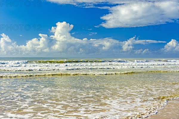 Waves and sea foam in the vividly colored sea