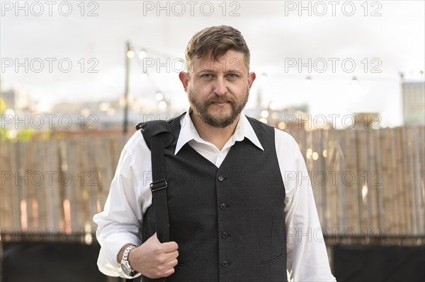 Portrait of an attractive businessman looking at camera before an after office