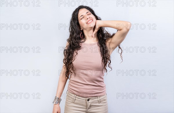 Young stressed woman with neck pain isolated. Tired girl with neck pain isolated. Stress and neck pain concept
