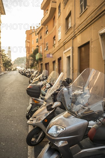 Many Motorcycles in a Row in City of Genoa