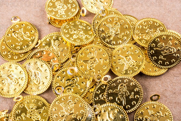 Spiral notebook and the gold coins on white background