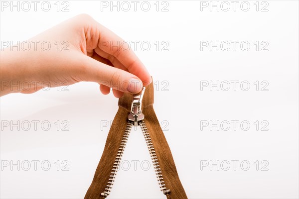 Hand holding color zipper on a white background