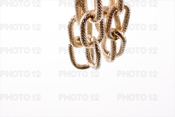 Gold color metal chain on white background