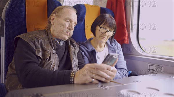 Elderly couple travel by train