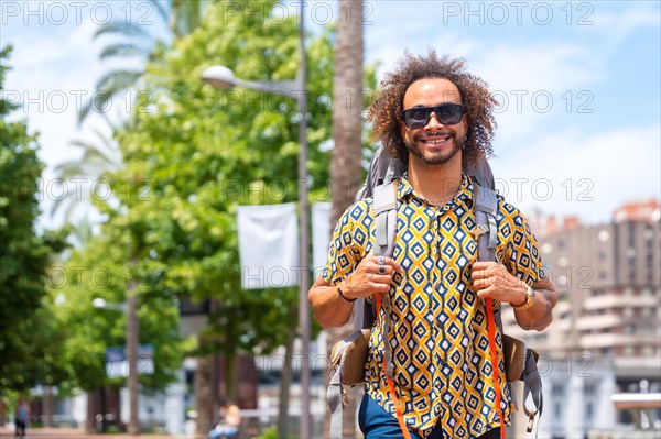 Afro hair man backpacking on summer vacation