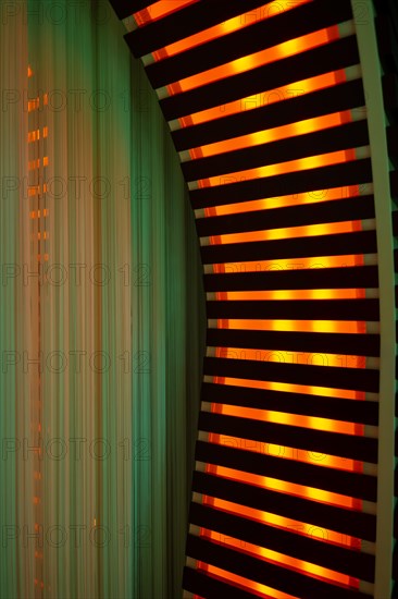 Illuminated Orange Stripes on a Modern Column in Switzerland